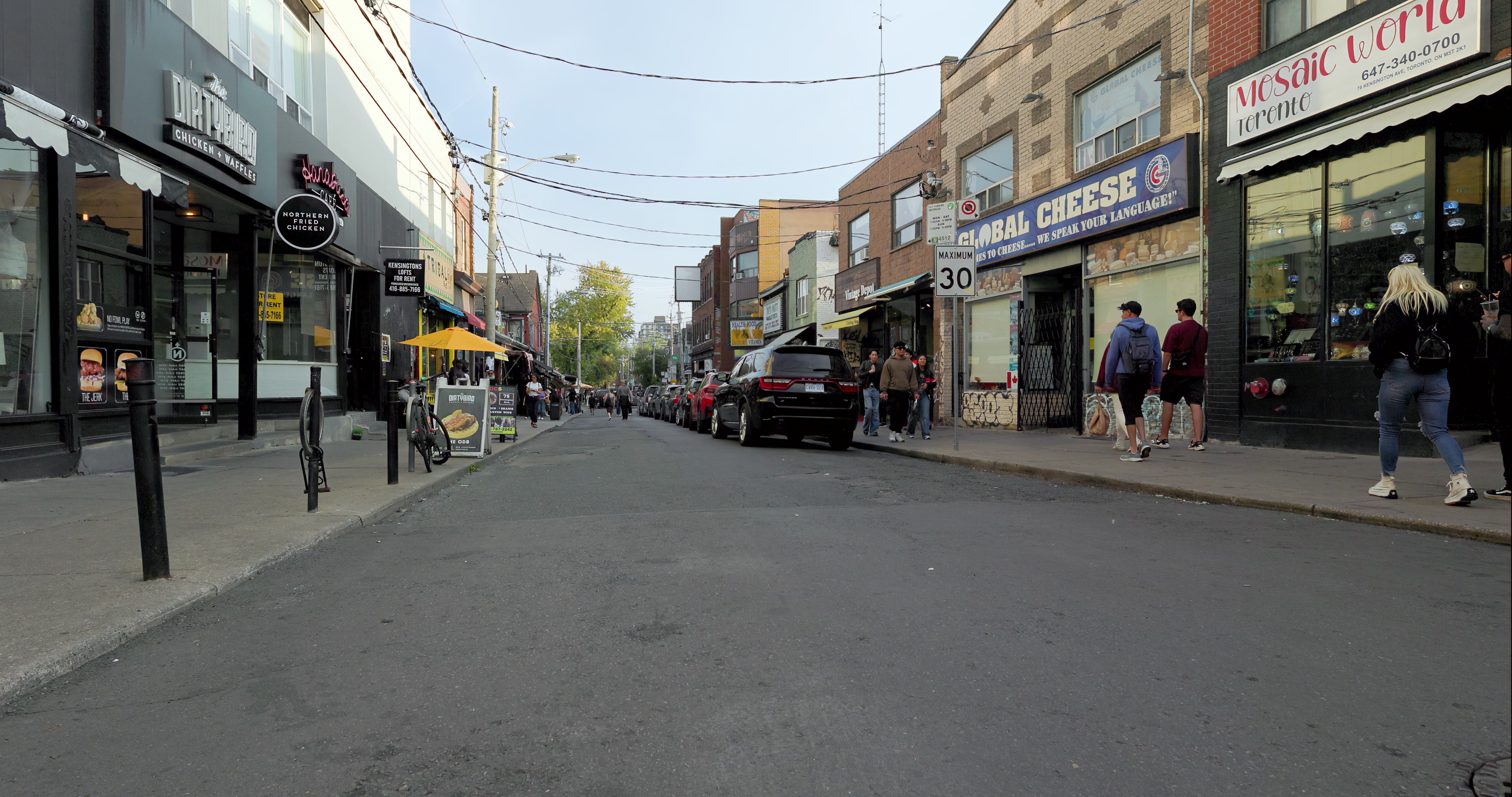 Pedestrians Walking Along Bustling Urban Shopping Street with Storefronts in Toronto — 4K stock footage