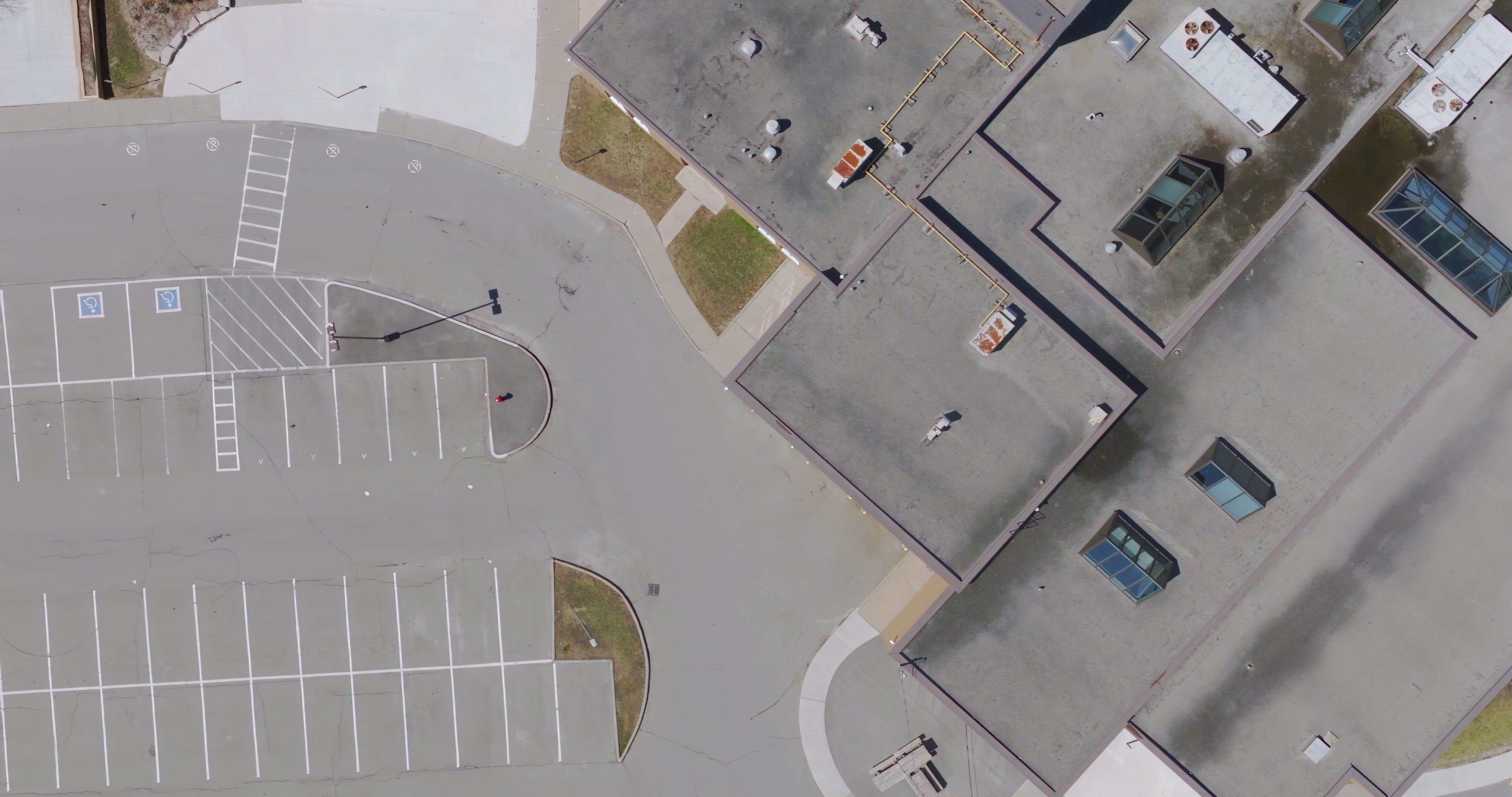Empty Parking Lot and Building Rooftop - Top Down — 4K stock footage