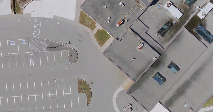 Empty Parking Lot and Building Rooftop - Top Down