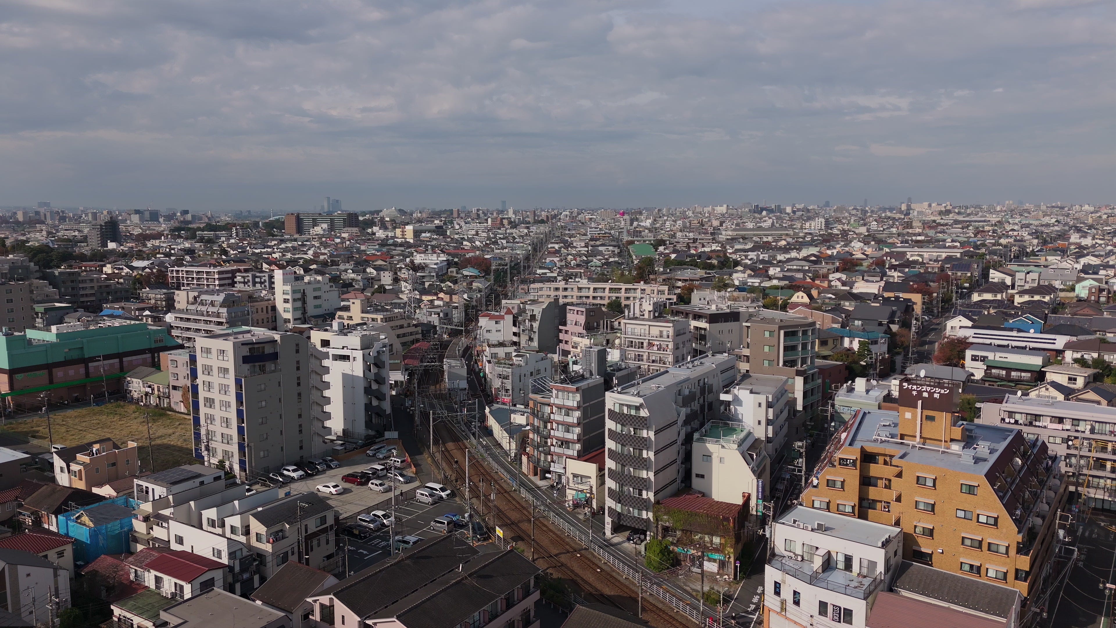 Japanese Suburban Cityscape with Railway Tracks - Aerial in Tokyo — 4K stock footage