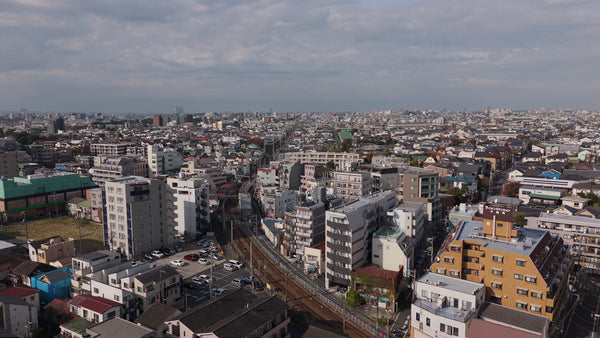 Japanese Suburban Cityscape with Railway Tracks - 4K Aerial