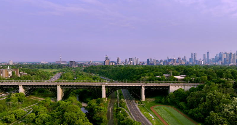 Bridge with City Skyline and Valley at Dusk - 5K Aerial