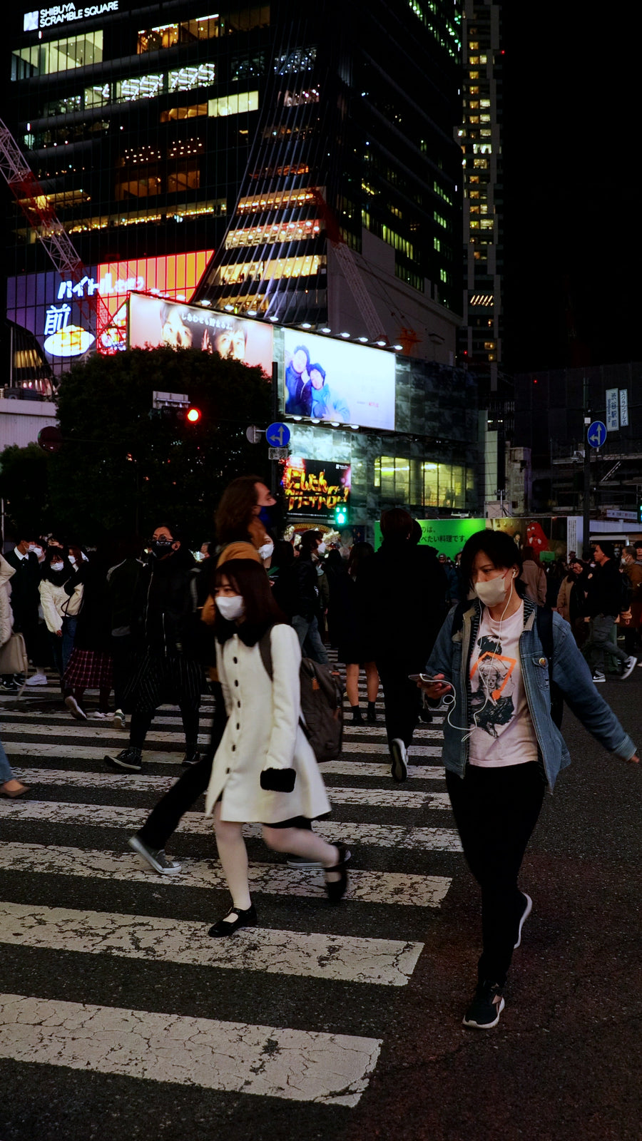 Crowded Shibuya Crossing at Night with Face Masks in Tokyo