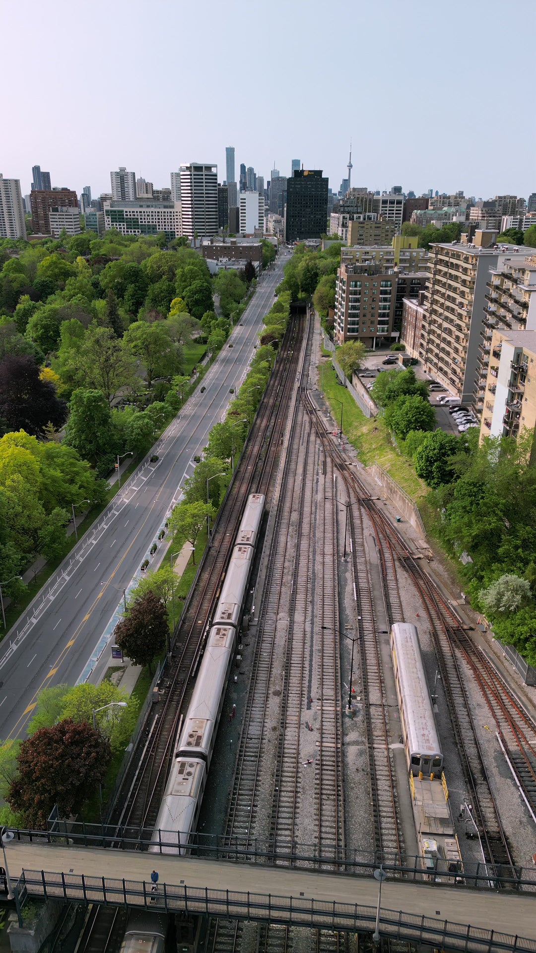 Aerial View of Commuter Train Traveling Towards Downtown Skyline — Premium 4K stock footage