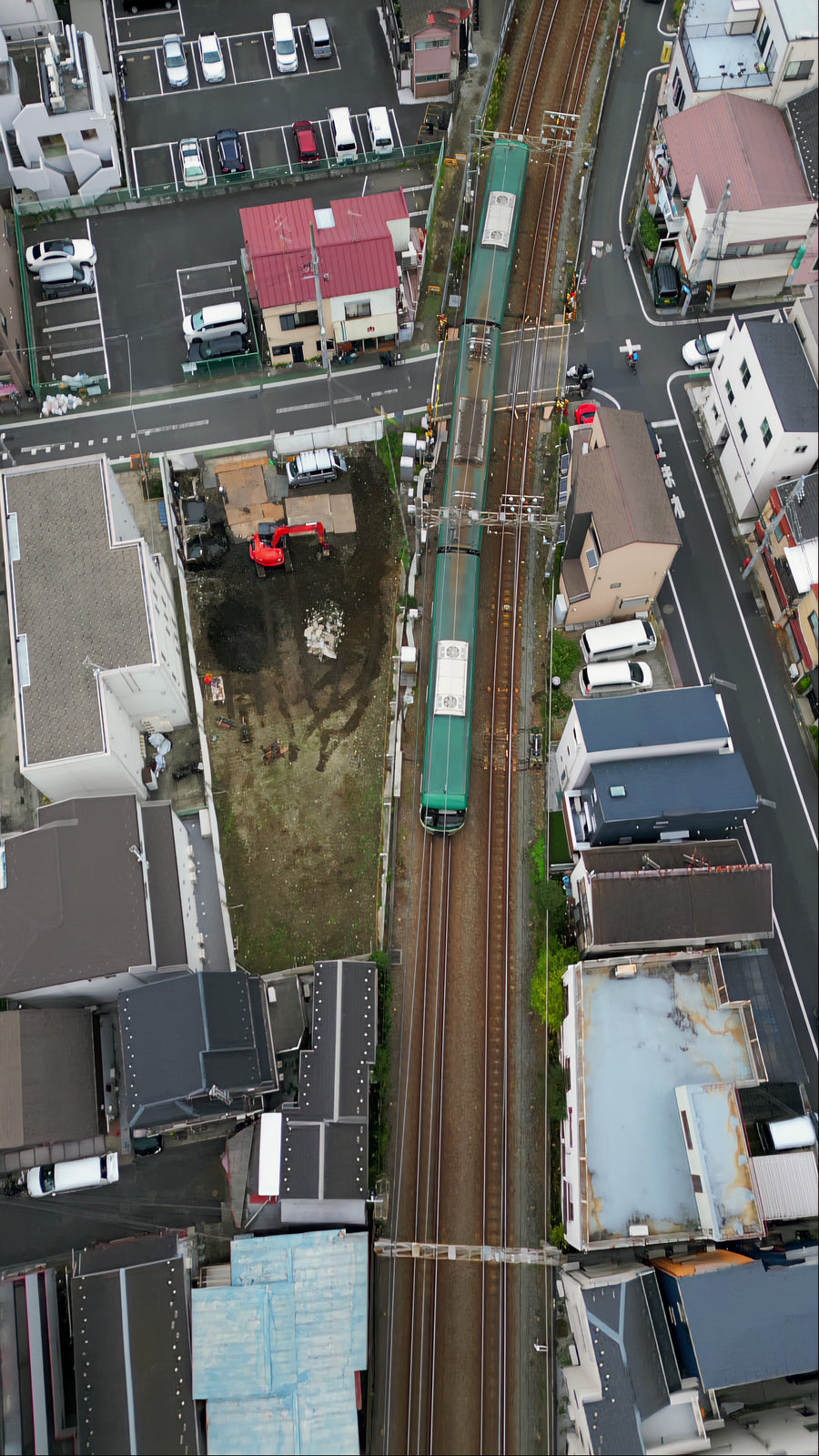 Green Train Through Japanese Neighborhood - Top Down