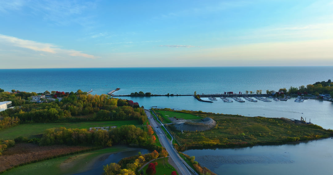 Aerial View of Coastal Marina and Peninsula at Golden Hour — Premium 4K stock footage