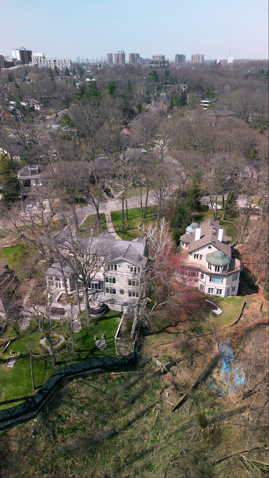 Luxury Lakeside Mansions with City Skyline - 5K Aerial