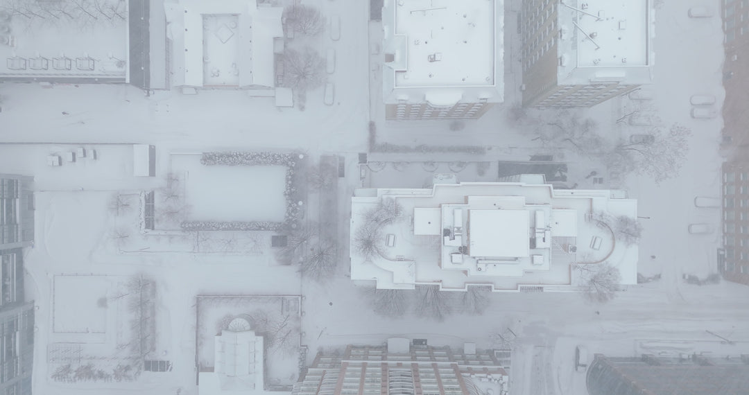 Aerial Top Down View of Snow-Covered Urban City Block in Heavy Snowfall — Premium 4K stock footage