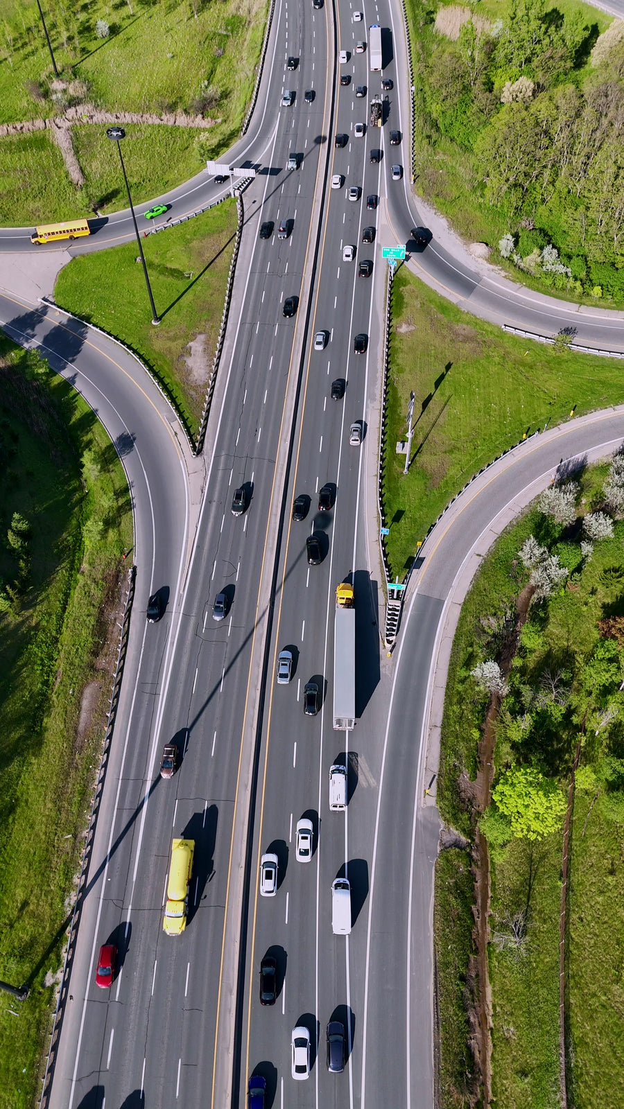 Highway Interchange with City Skyline - Vertical Aerial