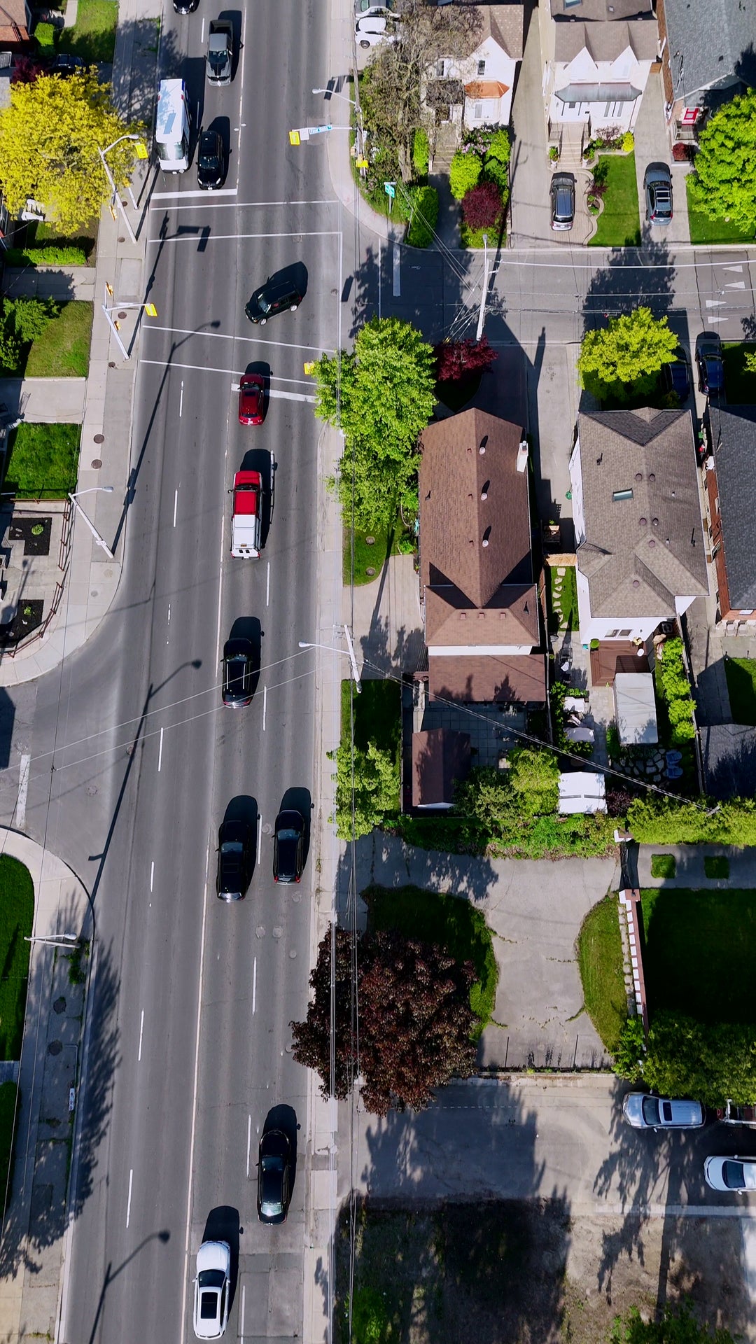 Aerial Top Down View of Suburban Street Traffic and Residential Houses — Premium 4K stock footage