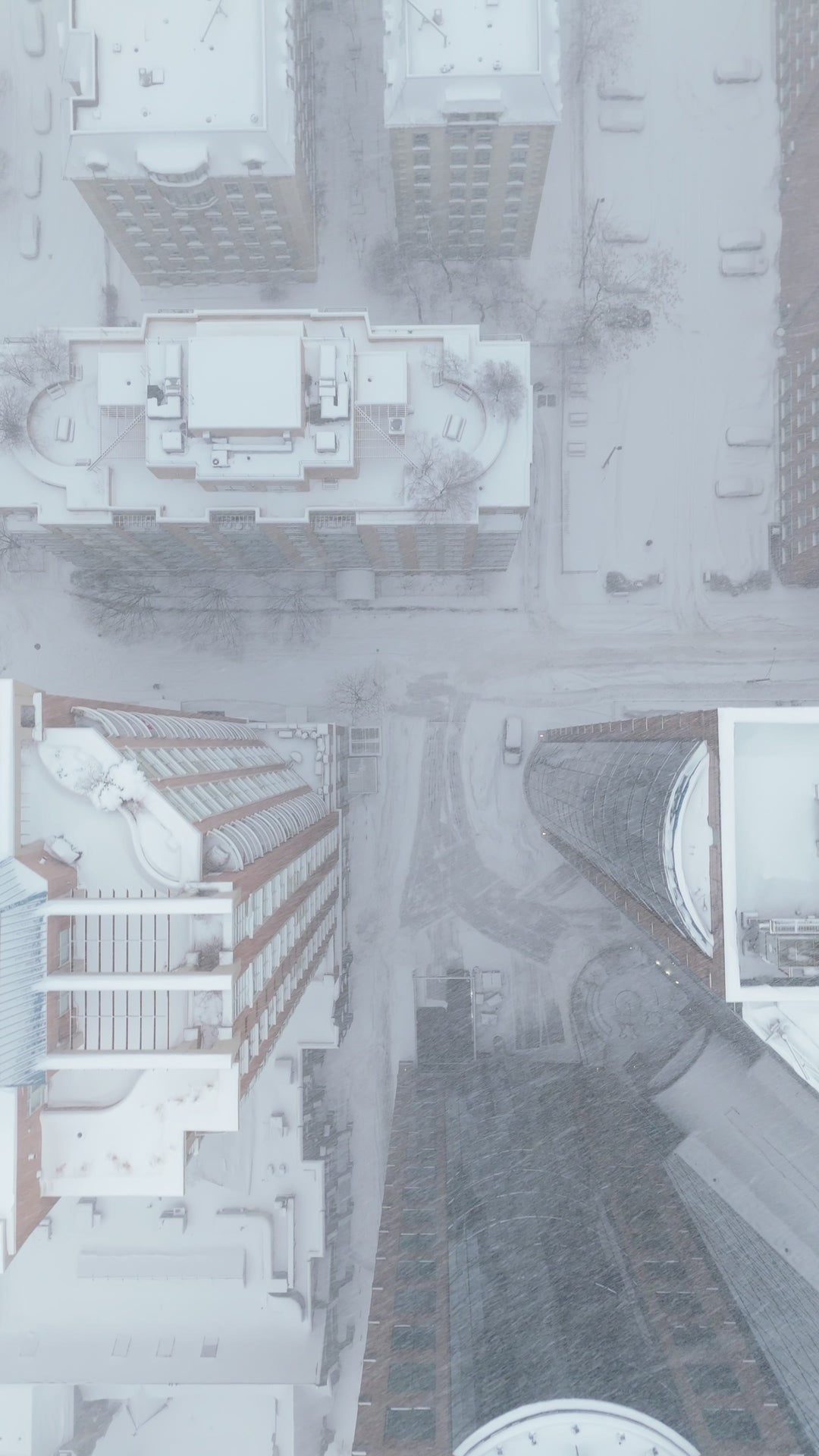 Aerial Top Down View of Snowy City Streets During Winter Storm — Premium 4K stock footage
