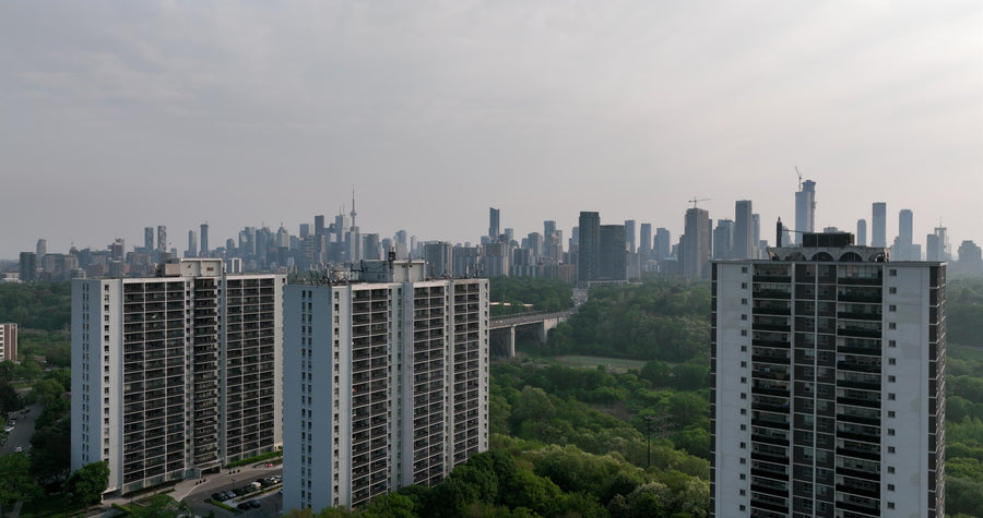 Residential Towers with Downtown Skyline at Dusk - 5K Aerial