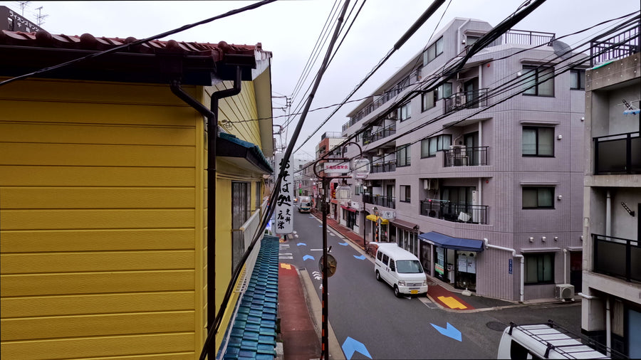 Quiet Residential Street in Tokyo Suburb with Traffic and Pedestrians