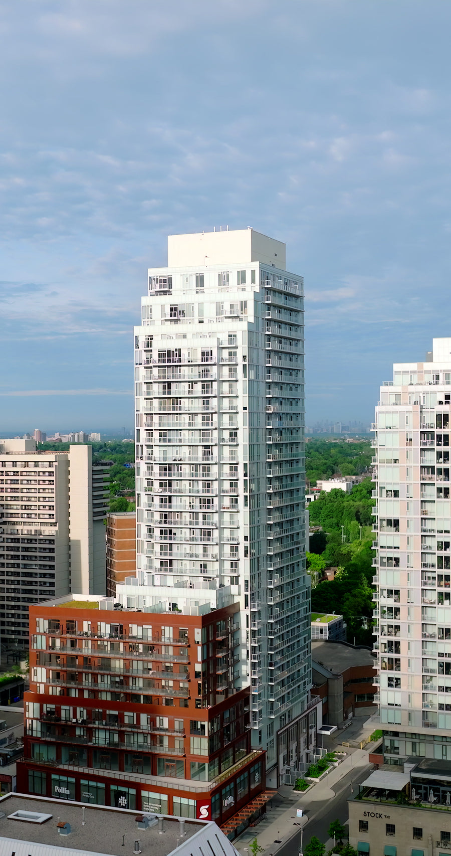 Modern High-Rise Residential Tower Aerial Pan in Urban Cityscape