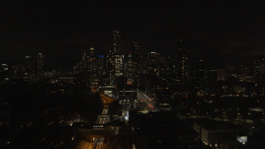 Aerial Night Cityscape with Highway Traffic and Illuminated Skyline — Premium 4K stock footage