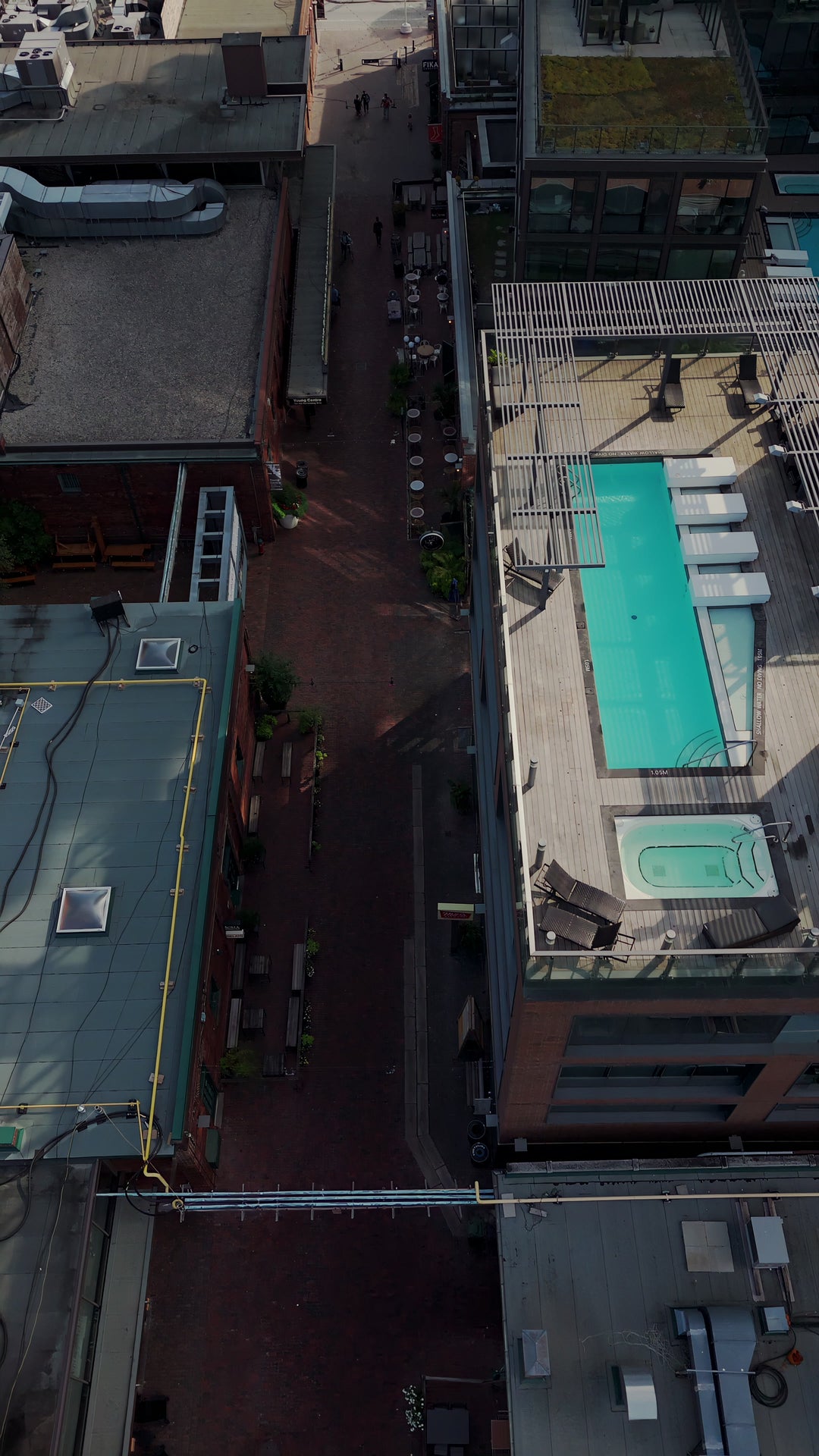 Modern City Rooftop Pool and Urban Architecture - Aerial at golden hour — 4K stock footage