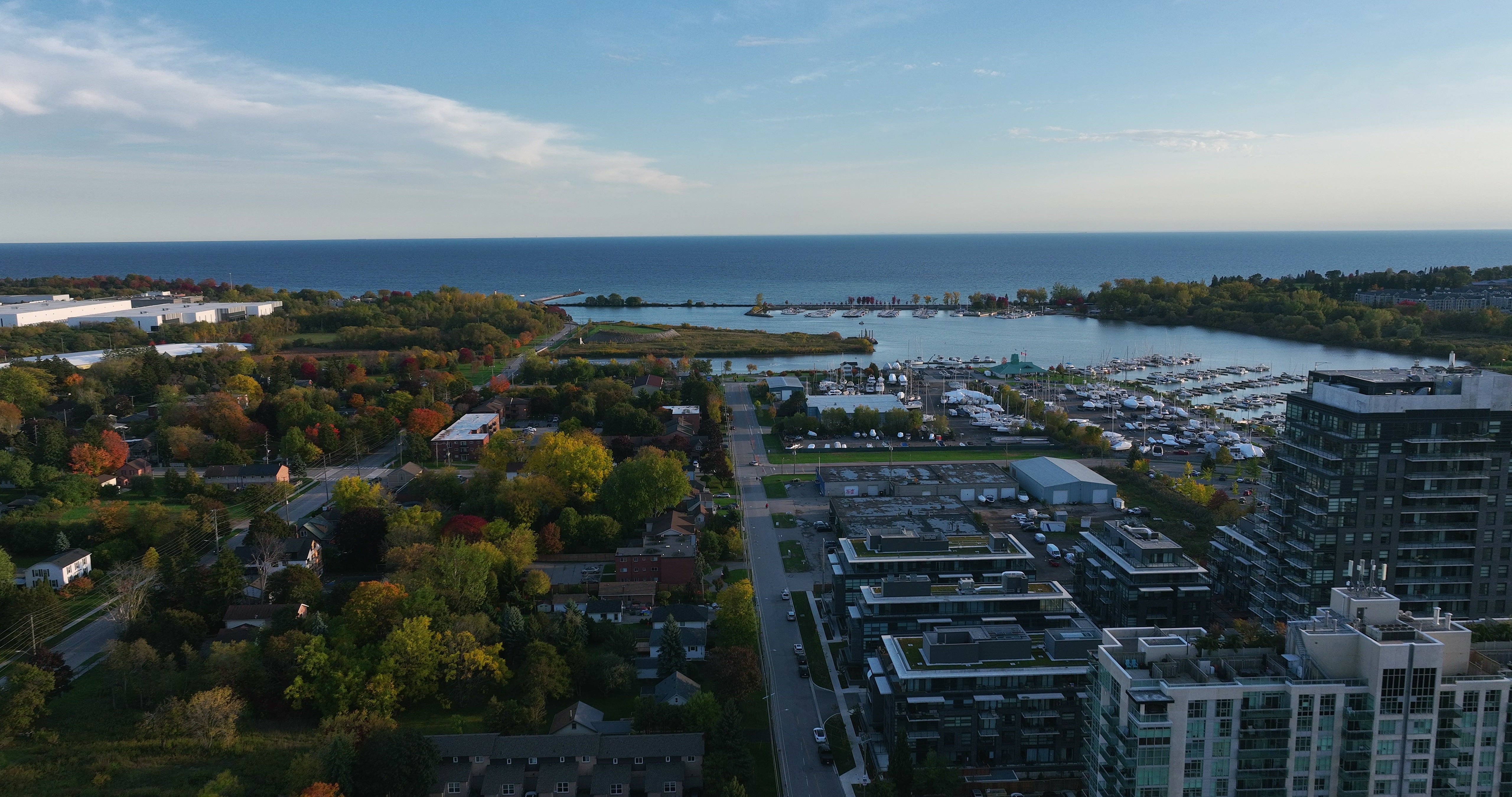 Coastal City Marina with Autumn Foliage - Aerial at sunset — 4K stock footage