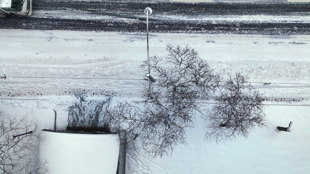 Snowy Urban Street with Truck and Pedestrians - Winter Aerial — 4K stock footage