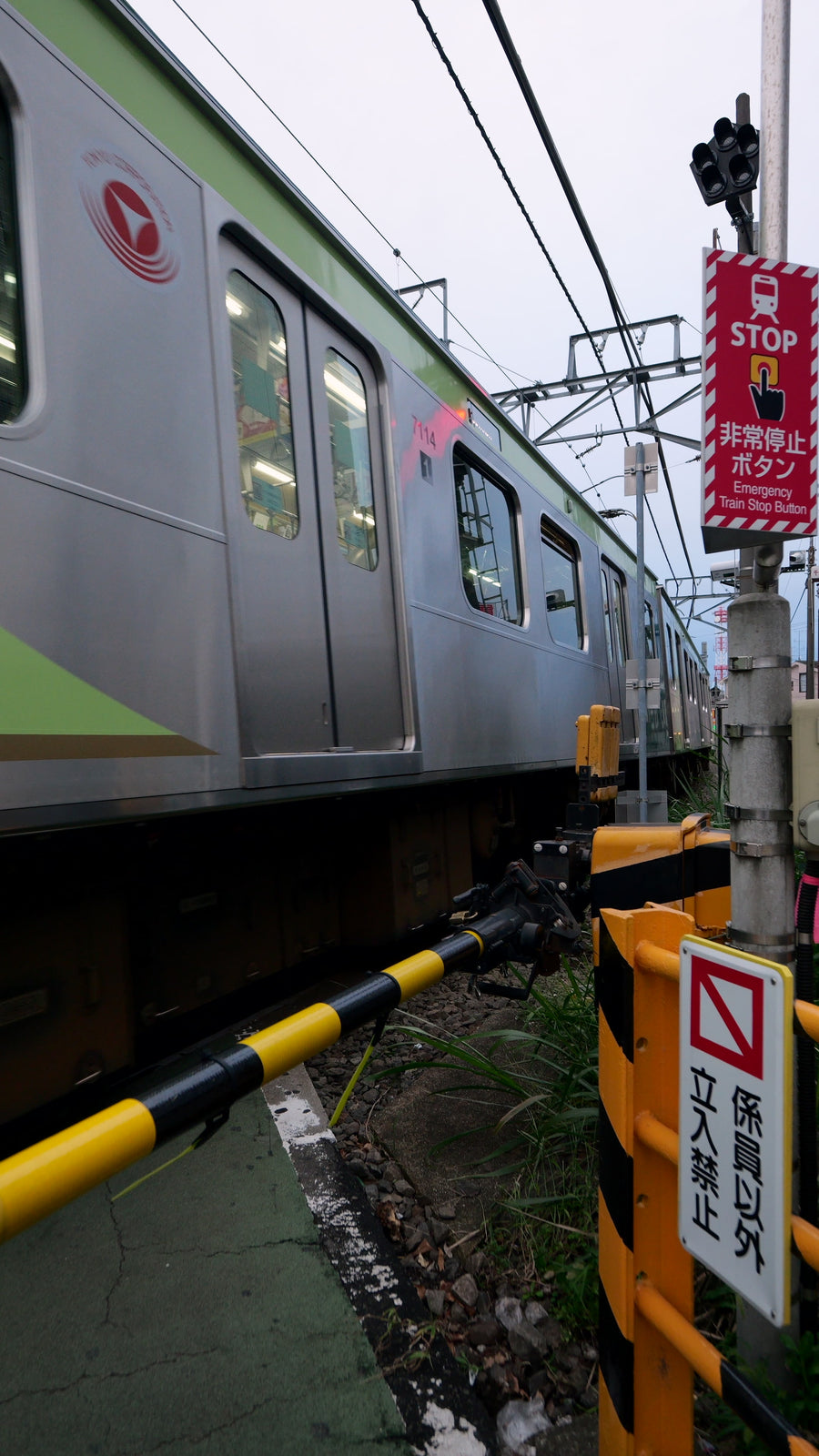 Japanese Commuter Train Passing Railroad Crossing