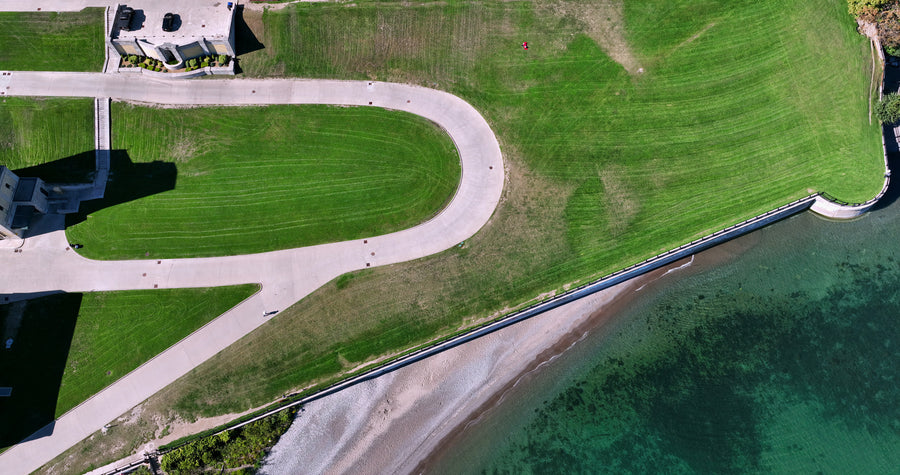 Curved Road Along Turquoise Waterfront - 5K Top Down