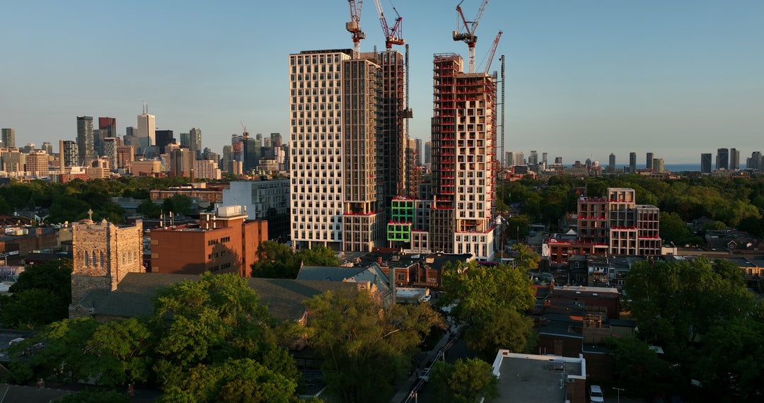 Aerial View of High-Rise Construction Site in Urban City at Sunset — Premium 4K stock footage