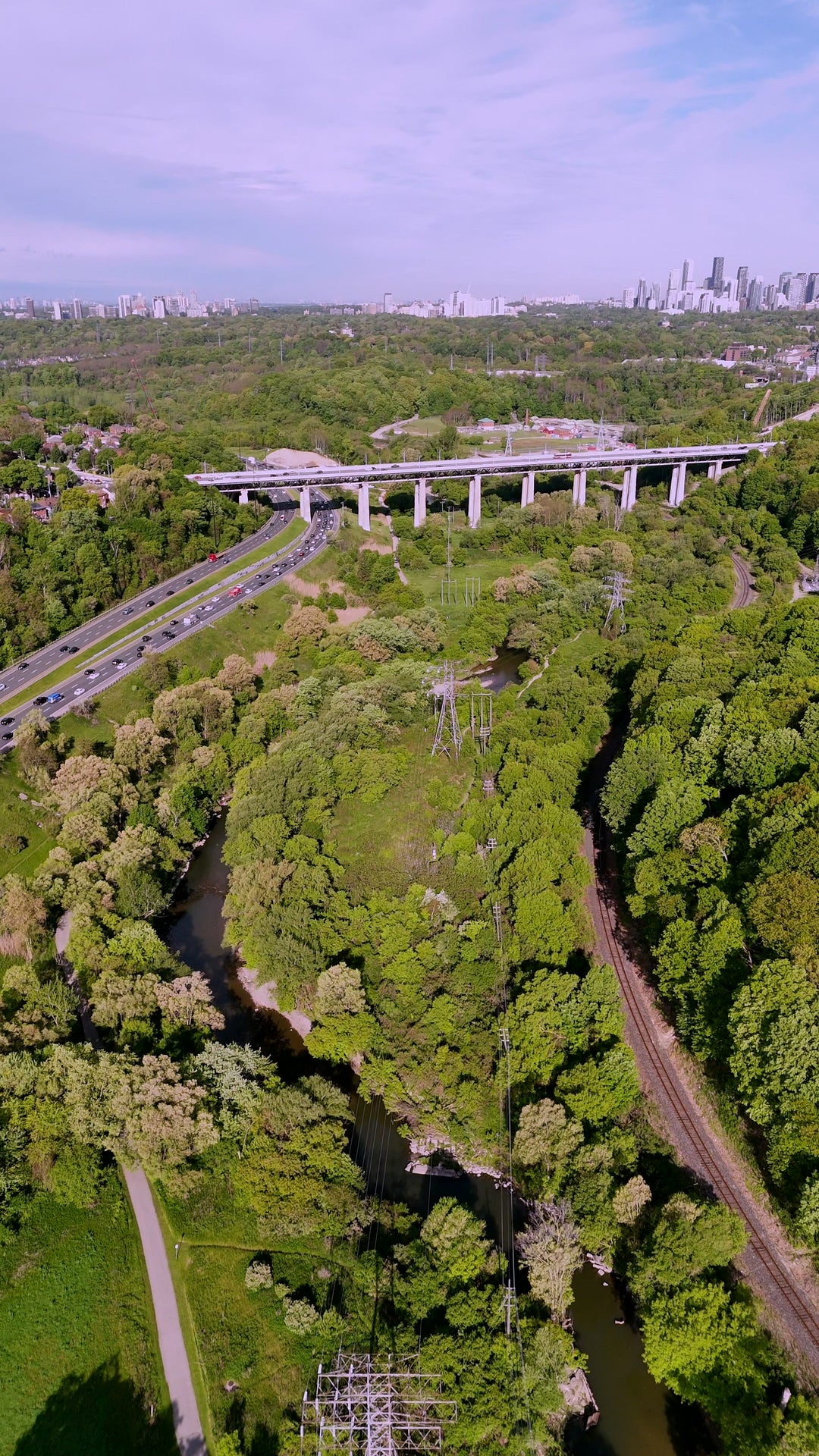 Highway Bridge Over Green Valley with Skyline - Aerial in Toronto in summer — 4K stock footage