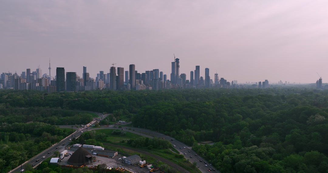 Toronto Skyline at Dusk with Highway and Forest - Aerial at sunset — 4K stock footage
