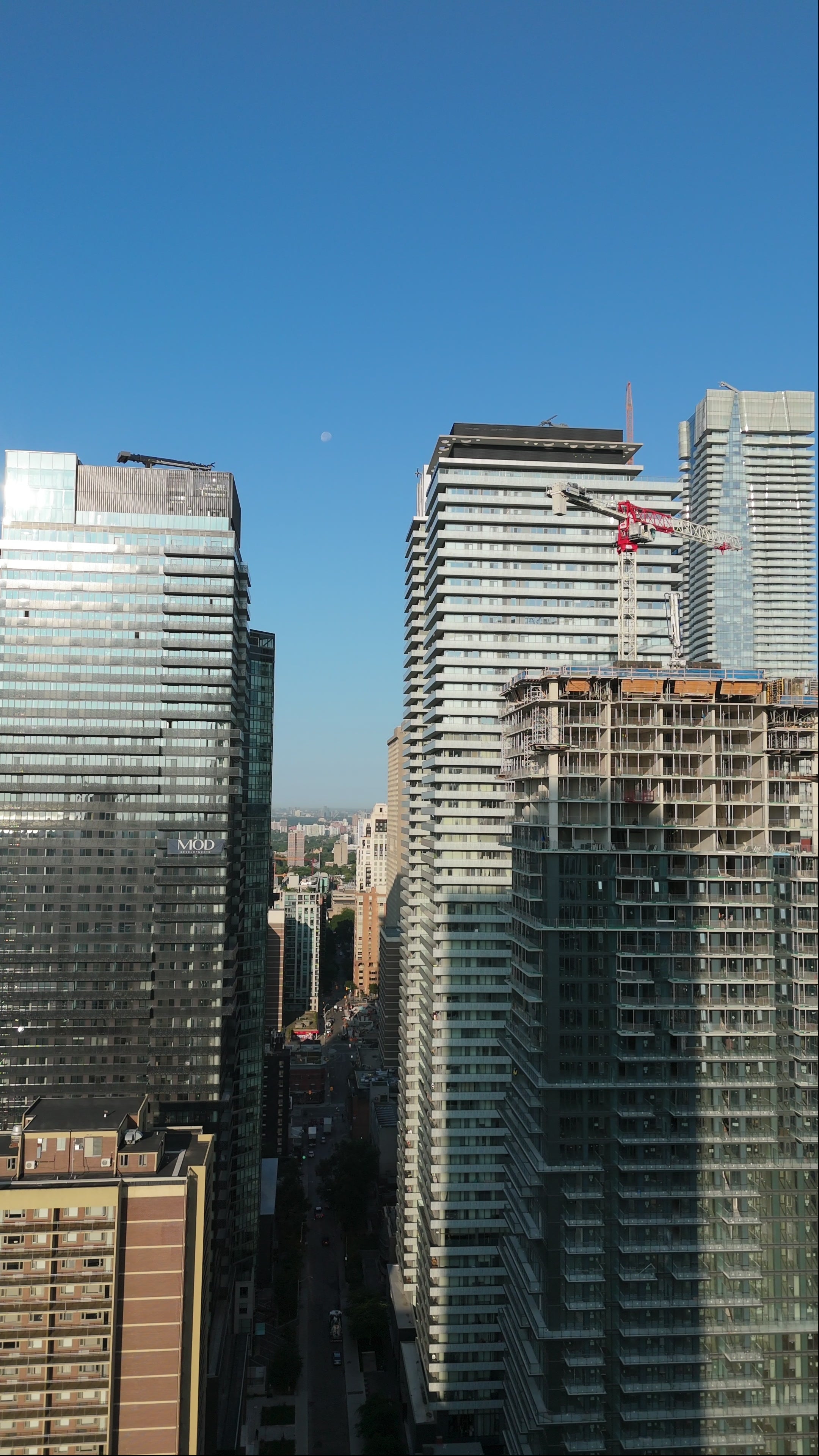 Modern Skyscrapers with Construction Cranes - Blue Skies Aerial in Toronto — 4K stock footage