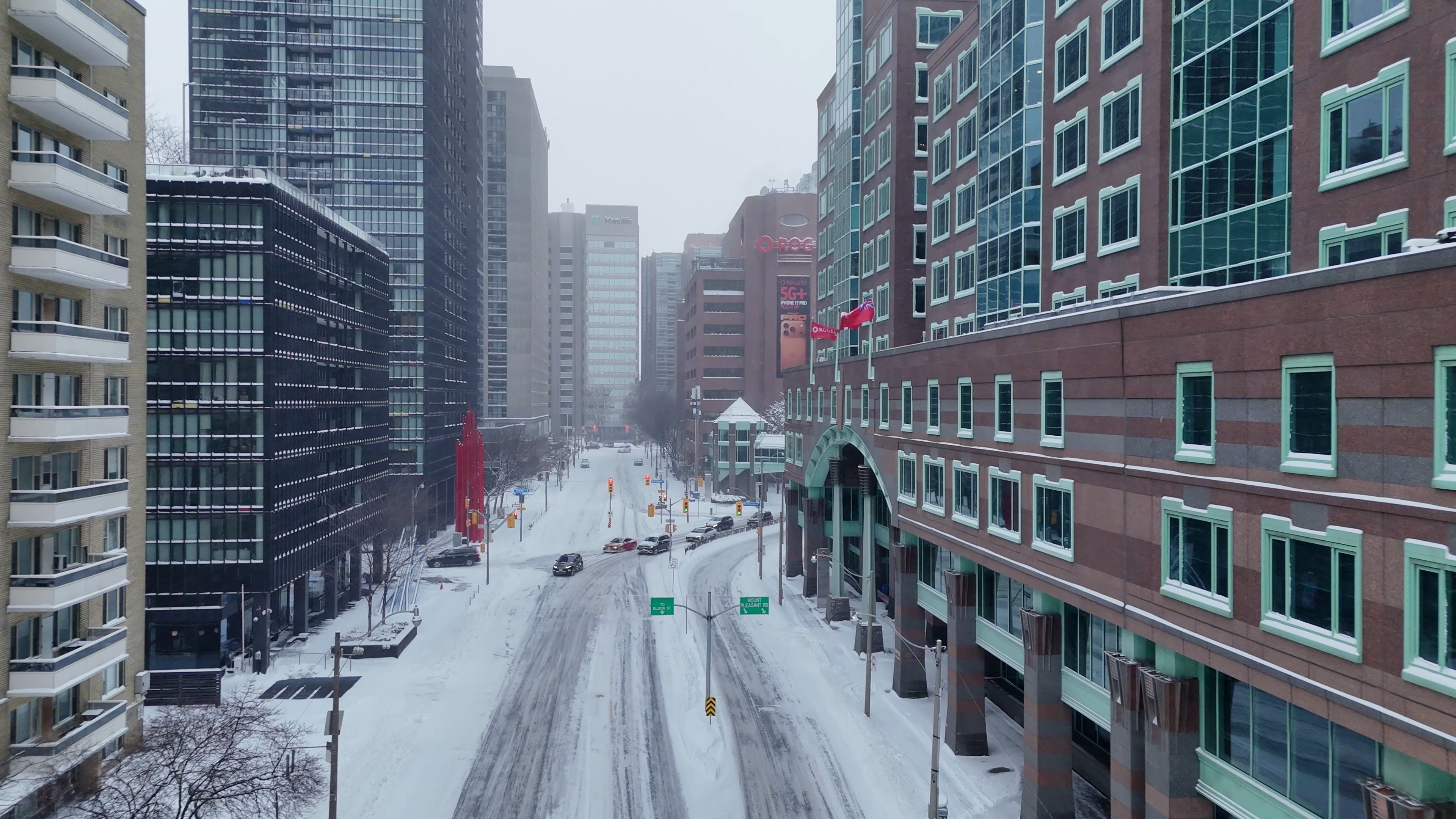 Snowy Toronto Street with Rogers Building - Aerial in winter — 4K stock footage