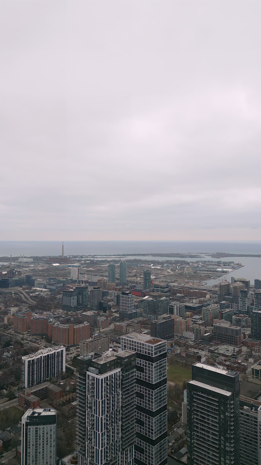 Modern City Skyline with Waterfront and Overcast Sky - 5K Aerial