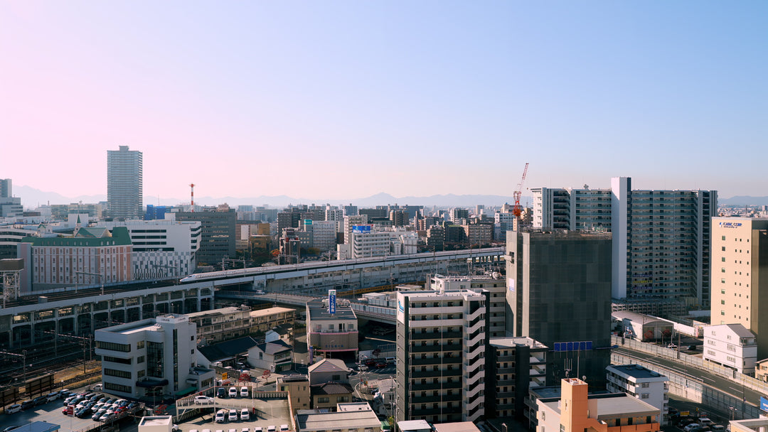 Japanese City with Shinkansen Bullet Train - Aerial in Tokyo at sunrise — 4K stock footage