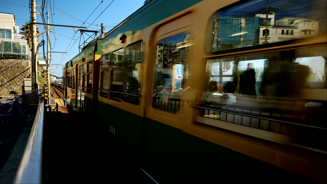 Japanese Coastal Train Passing by Ocean on Sunny Day