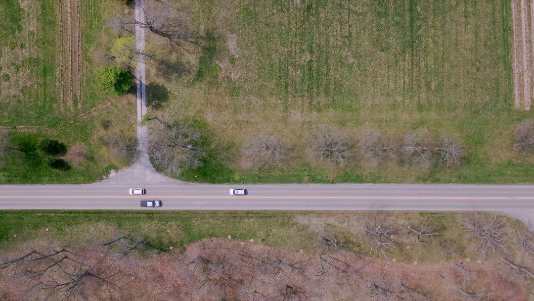 Aerial Top Down View of Cars Driving on Rural Highway Through Farmland — Premium 4K stock footage
