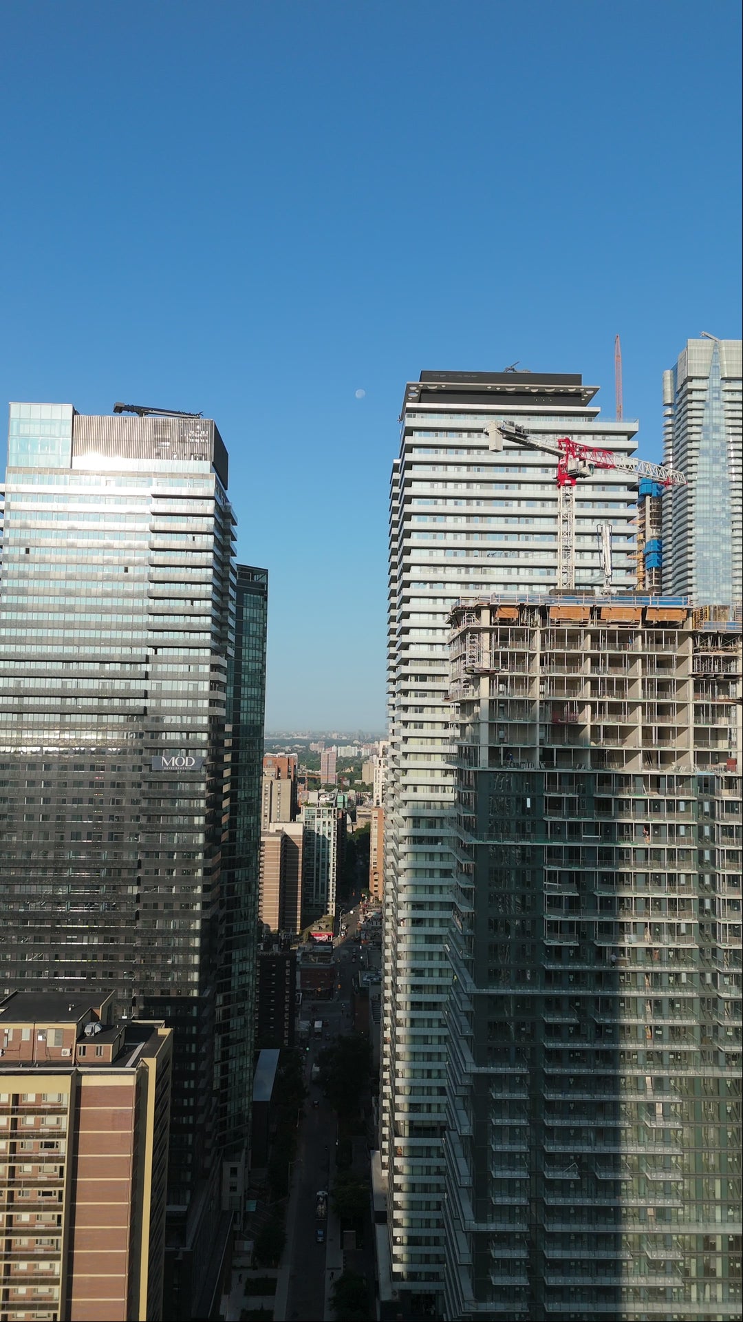 Modern Skyscrapers and Construction Crane - Blue Skies Aerial in Toronto — 4K stock footage