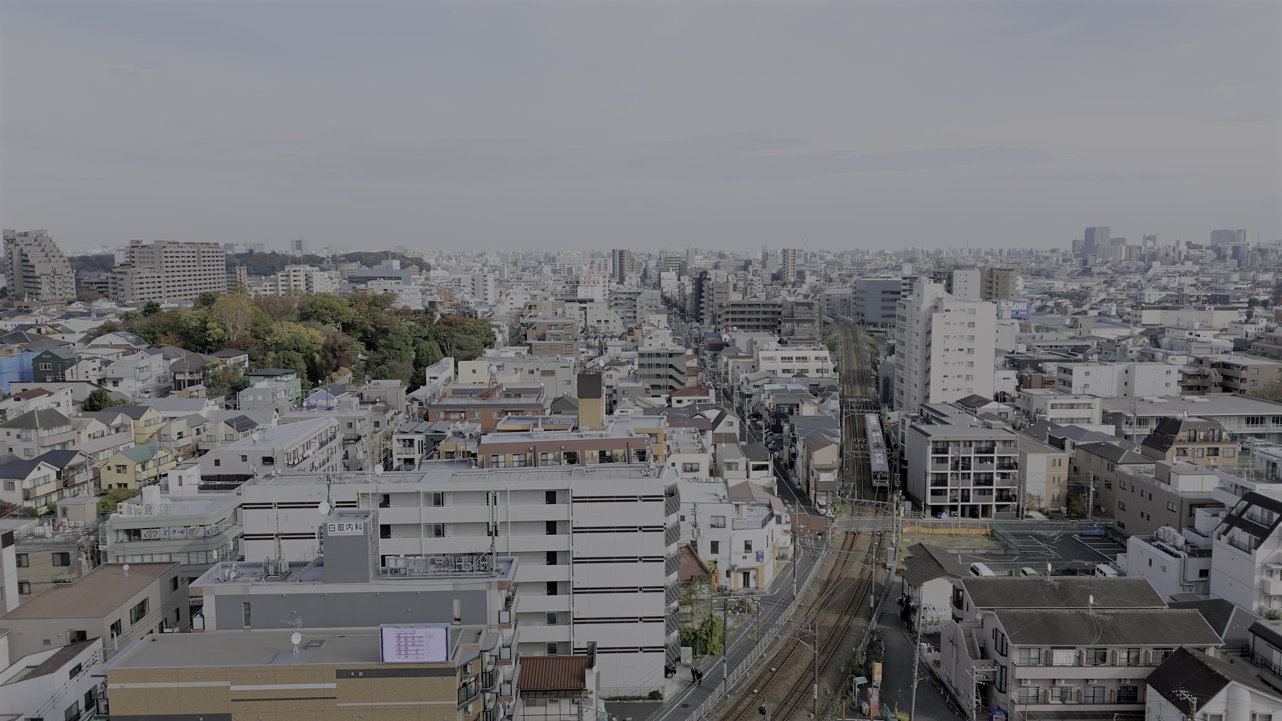 Tokyo Suburban Railway and Rooftops - Aerial — 4K stock footage
