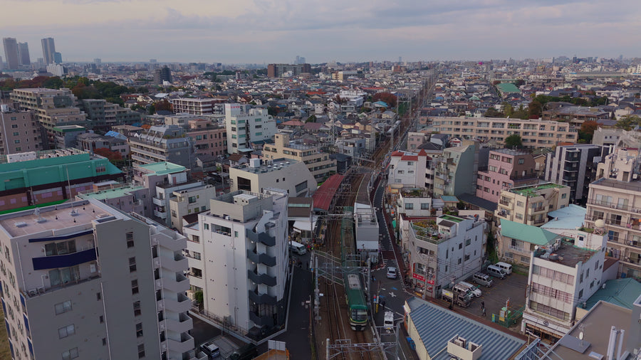 Tokyo Suburban Train Through Dense Neighborhood - Aerial