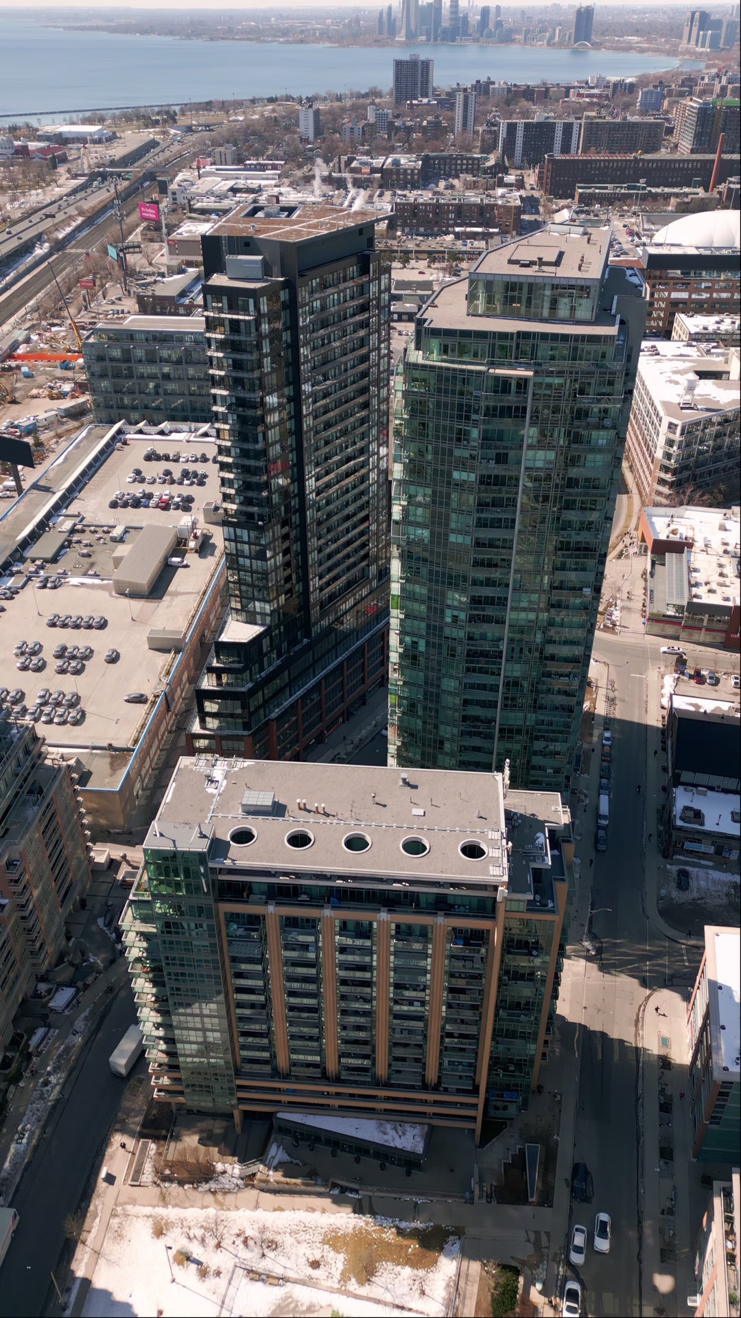 Aerial View of Modern Glass Skyscrapers in Waterfront City — Premium 8K stock footage