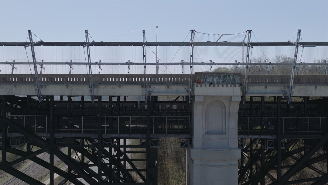 Aerial Drone View of Industrial Railway Bridge with Pedestrian — Premium 8K stock footage