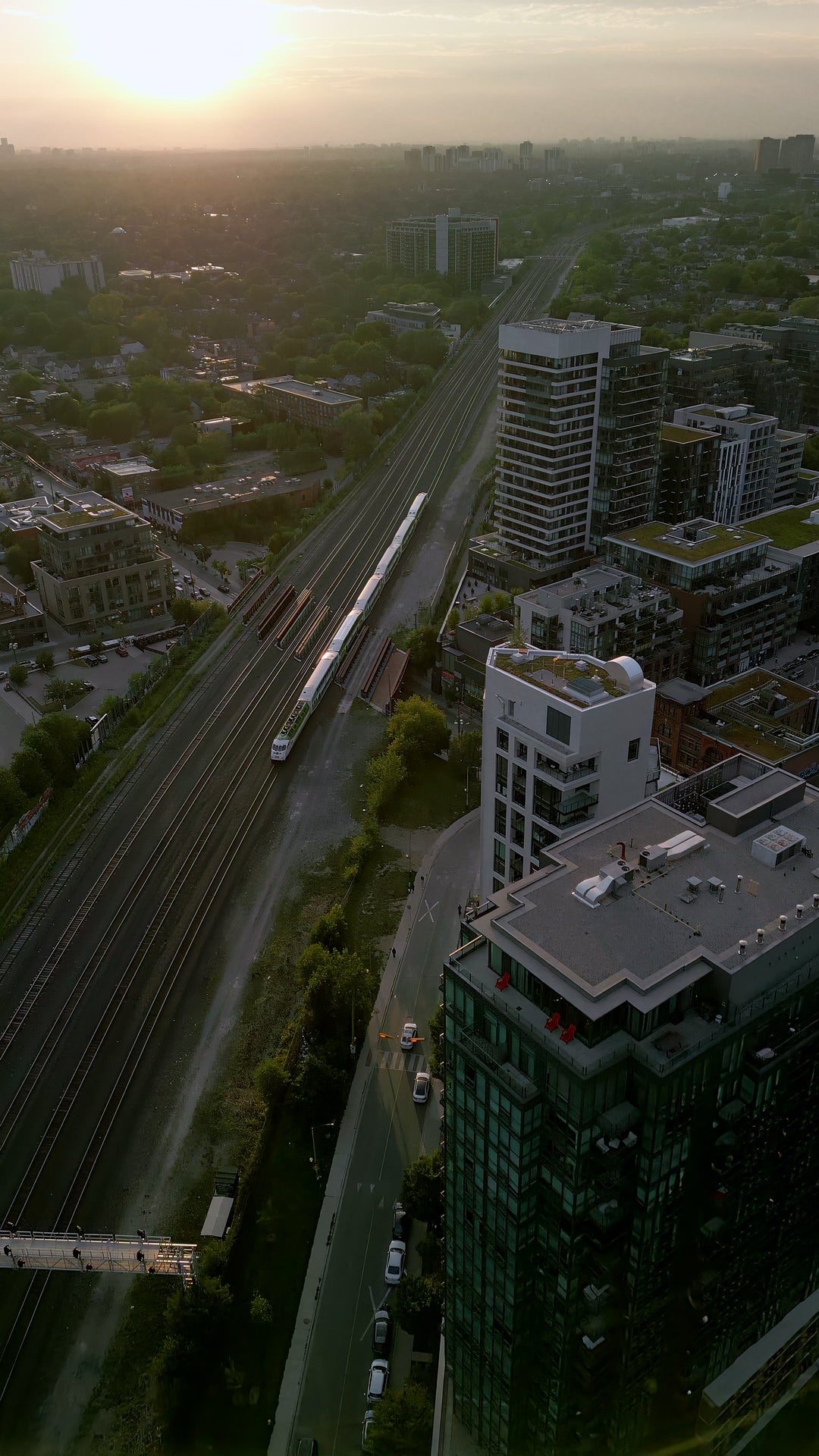 Train Tracks Through City at Sunset - Aerial Chase