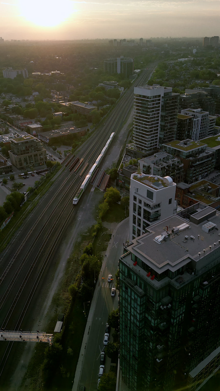 Train Tracks Through City at Sunset - Aerial Chase