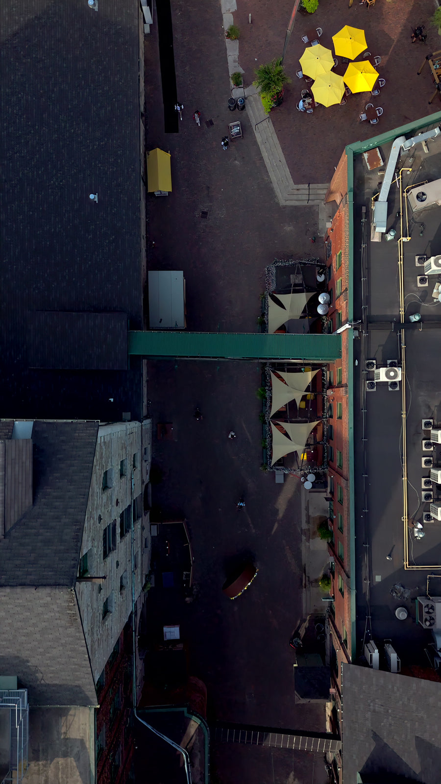 Yellow Umbrellas in Urban Courtyard - Top Down Aerial